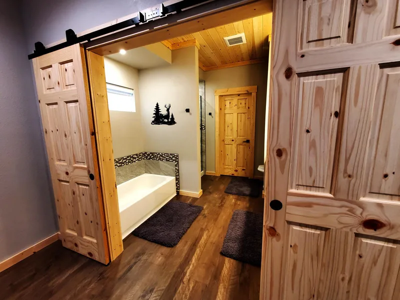 Barn doors and custom bathroom from the Glacier Park Retreat remodel