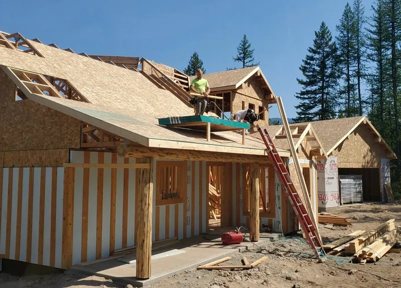 A Built Right home being framed on its site in Northwest Montana, crew on the roof