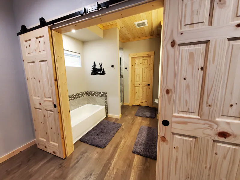 Barndoors and custom bathroom, Glacier Park Retreat by Built Right in Montana
