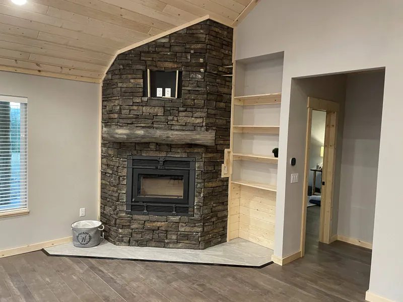 Faux concrete mantle, Glacier Park Retreat by Built Right in Montana
