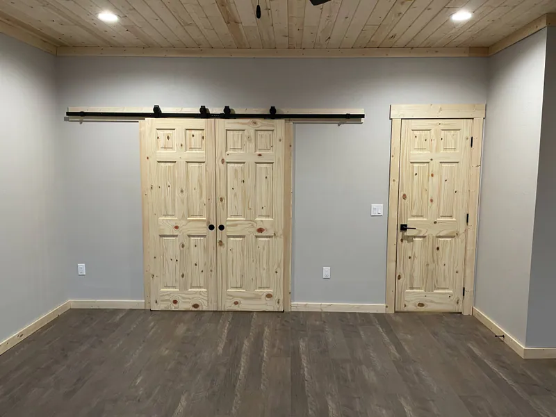 Knotty pine barndoors, Glacier Park Retreat by Built Right in Montana