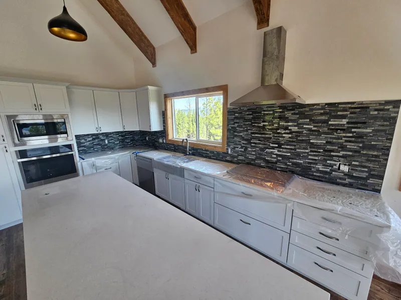 Custom kitchen, white quartz and custom backsplash, Kalispell Montana Mountain Views by Built Right in Montana