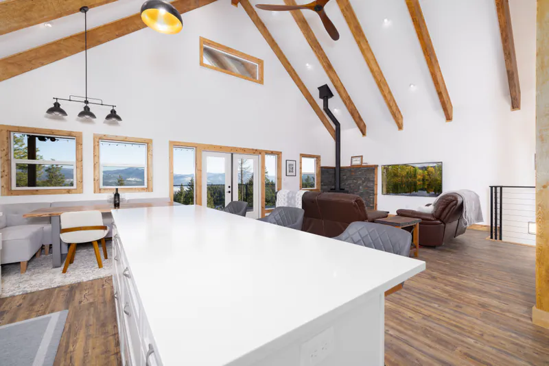 Structural timbers carrying an open living and dining room, by Built Right in Montana