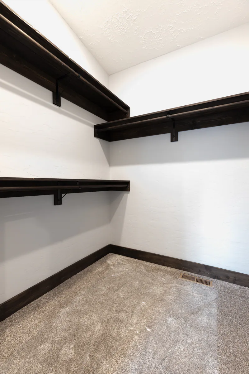 Dark pine master closet, Modern Living Montana Built by Built Right in Montana