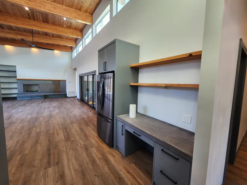 A desk, live-edge shelves and a concrete top, built into the wall, by Built Right in Montana