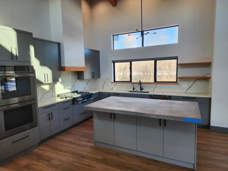 Custom kitchen: Huntwood cabinets, concrete and quartz countertops, River Frontage Montana Style by Built Right in Montana