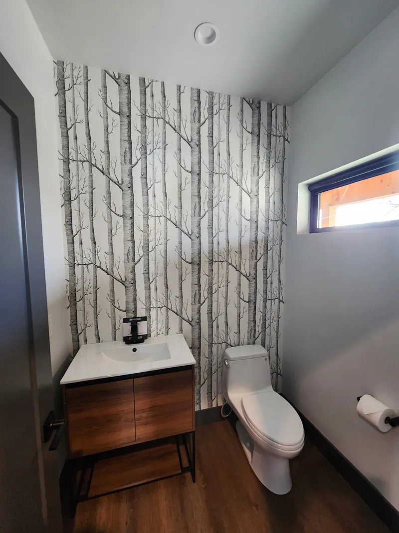 Modern powder room with custom vanity and designer wallpaper, River Frontage Montana Style by Built Right in Montana