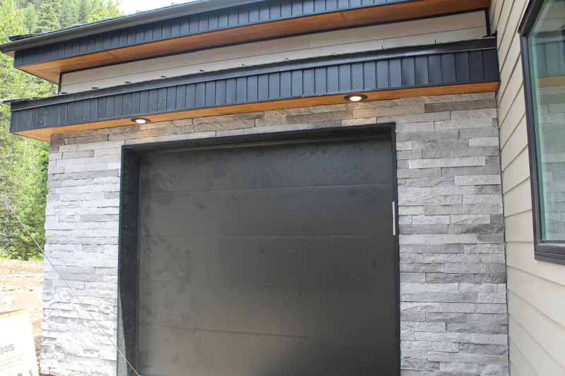 Matte black modern garage door, Secluded Flathead Montana Luxury by Built Right in Montana