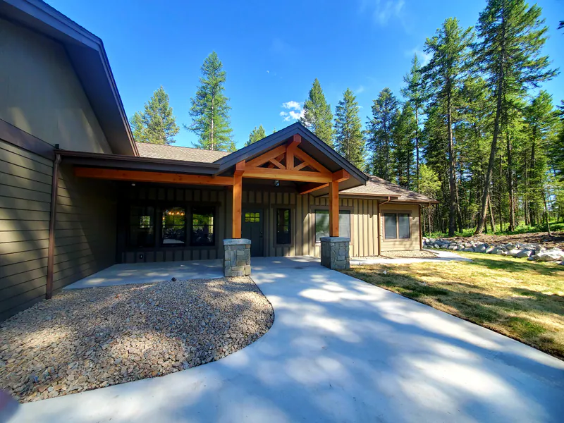 The front entry, timber posts on stone, the Reese family home by Built Right in Montana