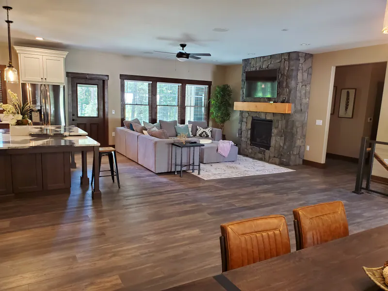 The great room, kitchen and fireplace, the Reese family home by Built Right in Montana