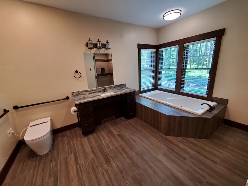 A soaking tub with an open approach, the Reese family home by Built Right in Montana