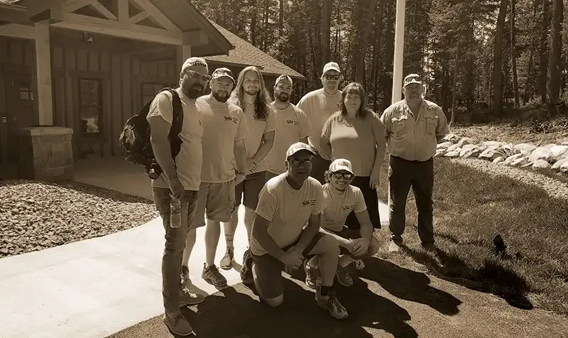 The Built Right in Montana team gathered in front of a custom home